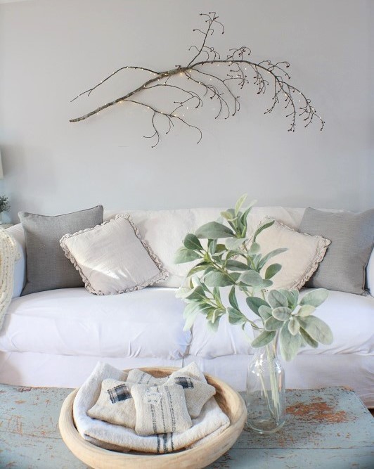 branches with fairy lights over couch