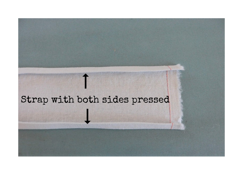 Cross back linen apron - step 1 strap with both sides pressed - label