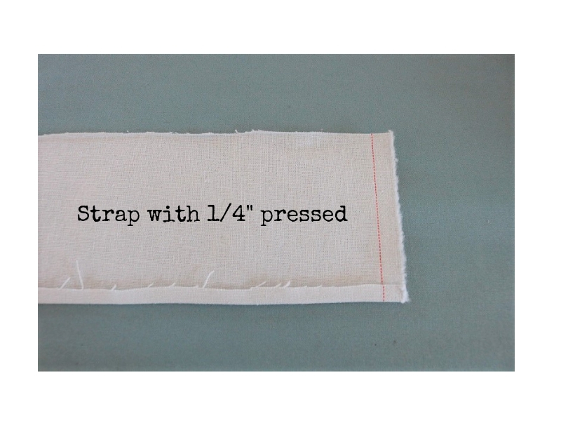 Cross back linen apron - step 1 strap with first press - label