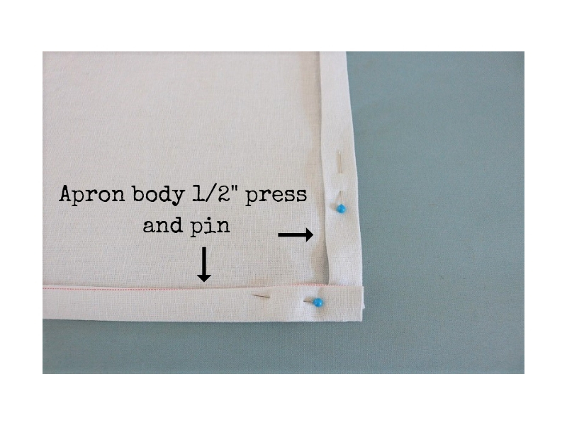Cross back linen apron - step 2 bottom hem and side press - label