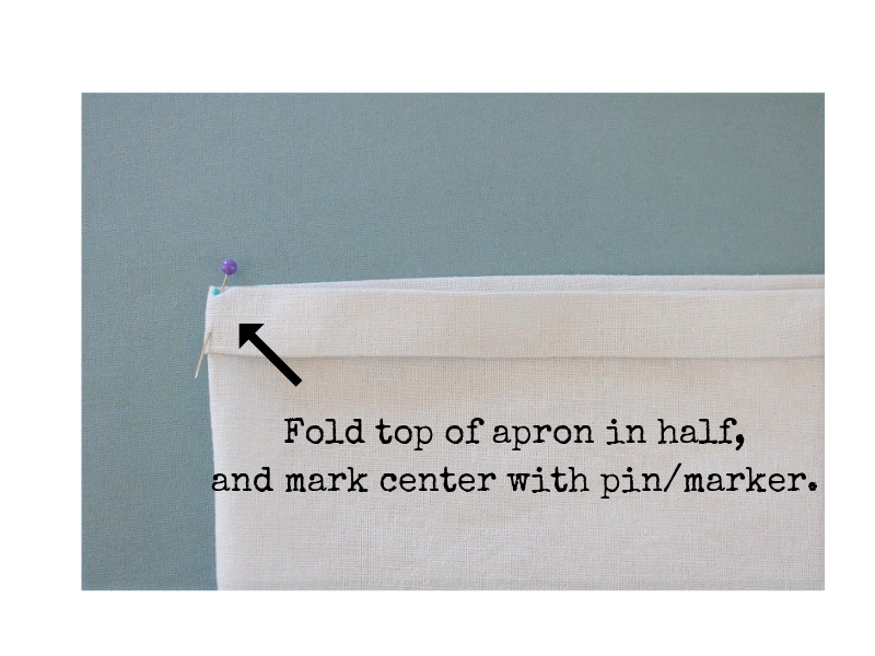 Cross back linen apron - step 4 fold apron to mark center - label