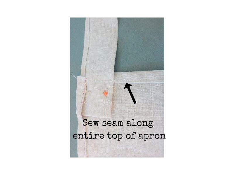 Cross back linen apron - step 5 - top seam to attach straps to apron - label