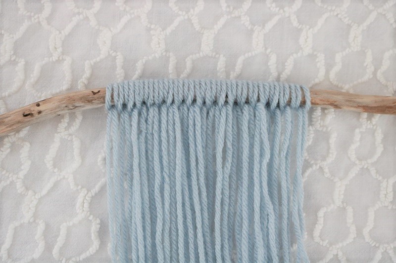 DIY Yarn Fringe Wall Hanging - Step 4 blue yarns