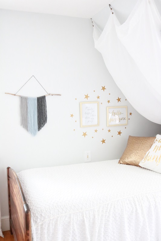 DIY Yarn Fringe Wall Hanging - finished hanging in room near bed