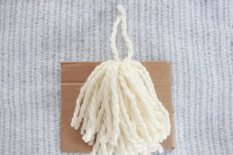 Farmhouse Tassel Pillows - fringe yarn around cardboard, cut bottom