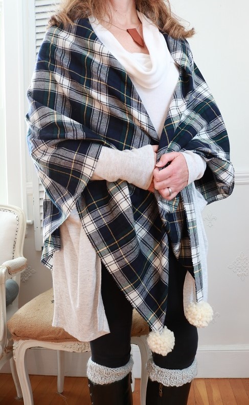 DIY Plaid Shawl - make this no-sew plaid blanket scarf with navy plaid fabric and pom poms. Wear it or toss it as a throw blanket! #fallshawl #plaidthrow #plaidshawl #blanketscarf