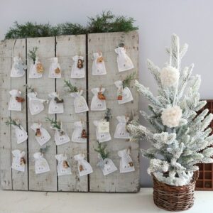 Make this easy DIY Advent Calendar by hanging mini muslin bags and ornaments. The bags are easy to sew to count down Advent! #adventcalendar #christmascalendar