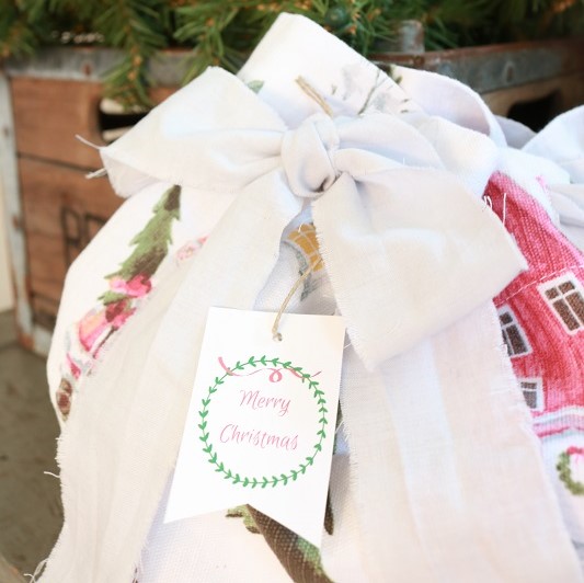 Make these EASY fabric Christmas gift bags with little sewing using fabric from a .....shower curtain! That's right! I'll show you how simple it is. #christmasgiftbags #fabricgiftbags #christmasdiy