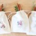 Make these Farmhouse Christmas gift bags! Stamp muslin bags, and embellish with flannel fabric. Stuff with Christmas goodies! #christmasgiftbag #farmhousechristmas