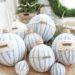 Make these easy DIY ticking stripe Christmas ornaments out of styrofoam balls, ticking fabric and fun embellishments - including wine corks! #diyornaments #christmasornaments #tickingstripe