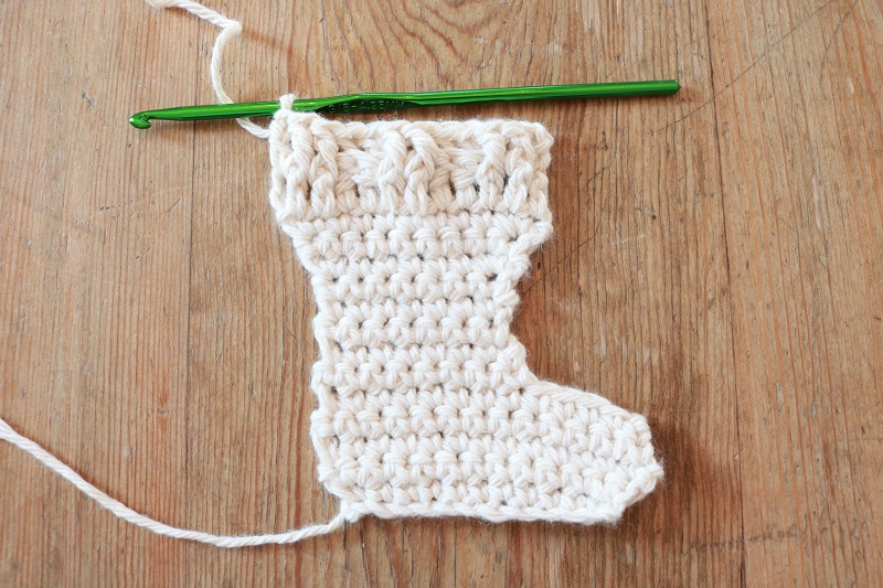 Here's a simple crochet pattern for a mini Christmas stocking ornament.  Hang it on the tree or make several for a Christmas garland!  #freecrochetpattern #crochetornament #crochetstocking