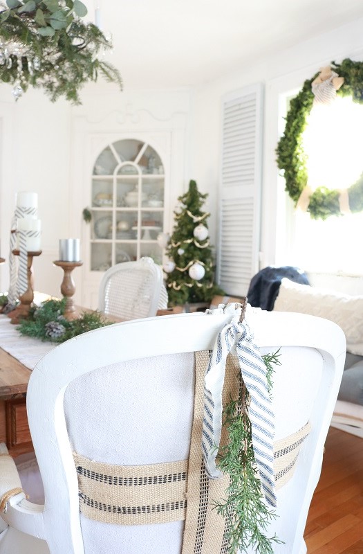 Deck the halls for a farmhouse Christmas with ticking stripe fabric.  This year I decorated our dining room with a farmhouse style theme and ticking stripes fabric.  Blue and white galore!  #farmhousechristmas #tickingstripes #christmasdiningroom