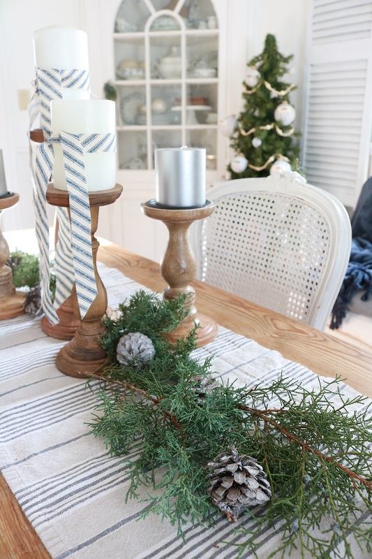 Deck the halls for a farmhouse Christmas with ticking stripe fabric.  This year I decorated our dining room with a farmhouse style theme and ticking stripes fabric.  Blue and white galore!  #farmhousechristmas #tickingstripes #christmasdiningroom