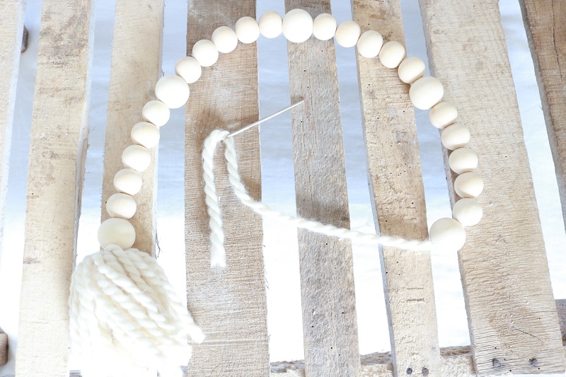 Farmhouse Style Wood Bead Garland Tassel - loop yarn through beads