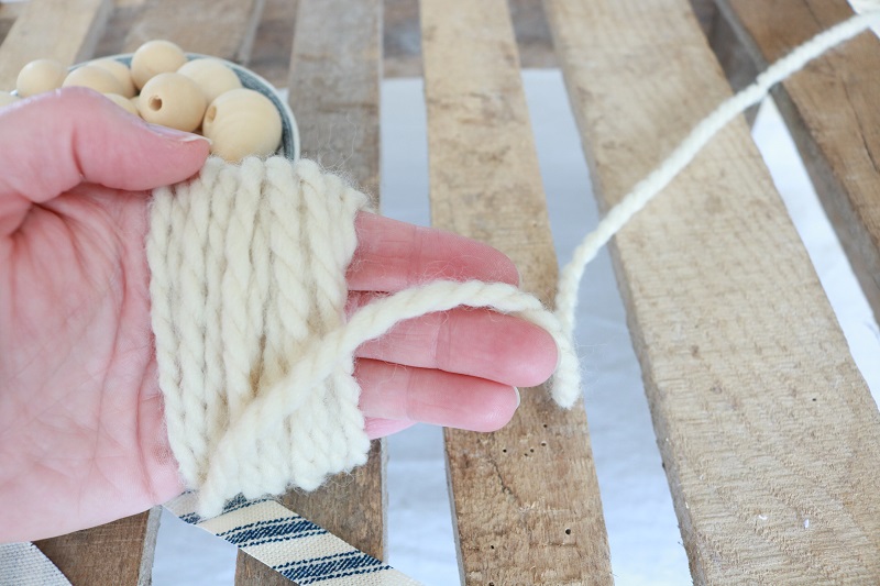 Farmhouse Style Wood Bead Garland Tassel - wrap yarn around hand