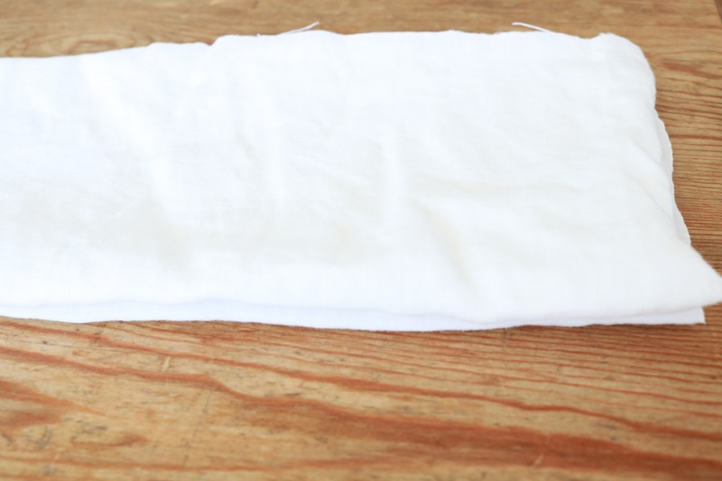 Shibori Tie Dye Pillows - white linen square folded accordion style lengthwise