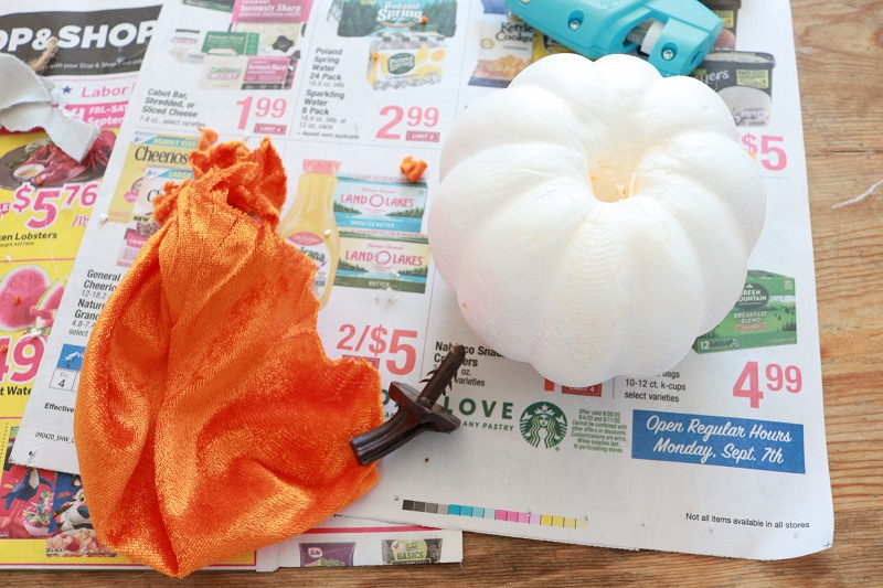 DIY Dollar Tree Fabric Pumpkins - remove stem and fabric from orange pumpkin