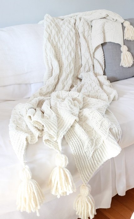 DIY Blanket Tassel - finished blanket tassels on sofa, closeup cropped