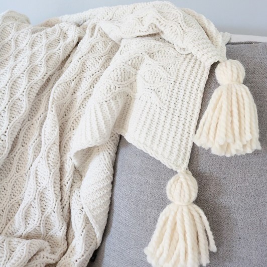 DIY Blanket Tassel - finished blanket tassels on sofa, closeup of tassels feature image
