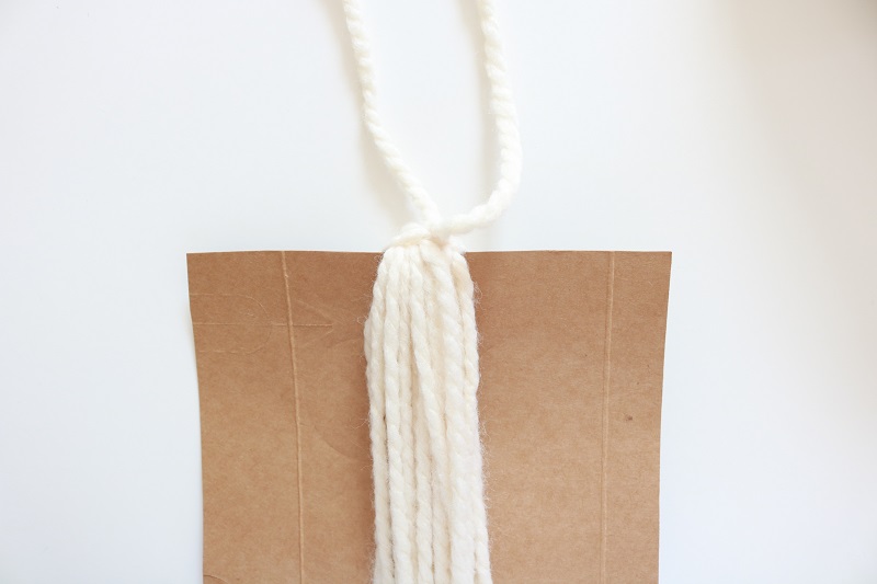 DIY Blanket Tassel - tie yarn on cardboard