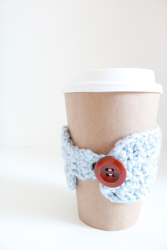 Crochet Coffee Cup Cozy - finished cozy around cup with button shown