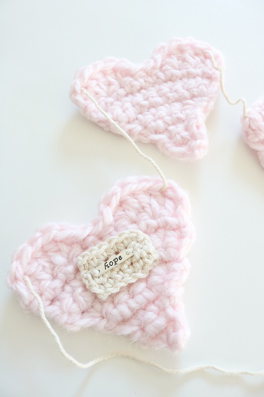 Crochet Heart Garland - garland on table, closeup of hope