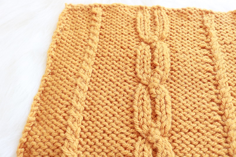Fall Cable 8 inch Square Knit Pattern - finished square on fur, closeup