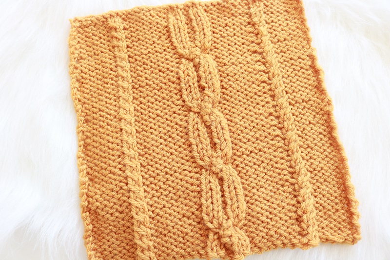 Fall Cable 8 inch Square Knit Pattern - finished square on fur