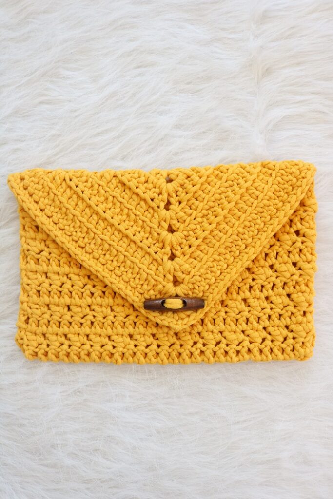 crochet clutch in saffron color