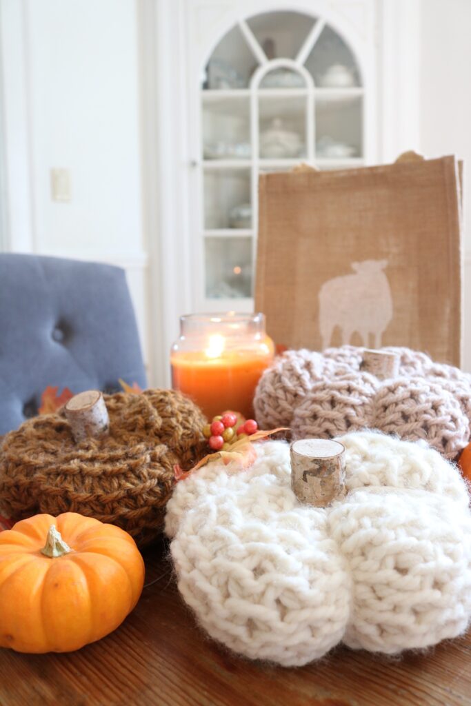 knit pumpkins displayed on table