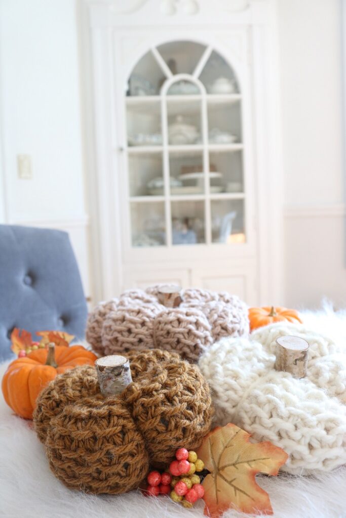 knit pumpkins displayed on table