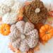 knit pumpkins displayed with real pumpkins