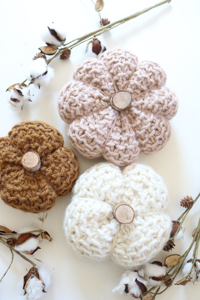 knit pumpkins displayed on table
