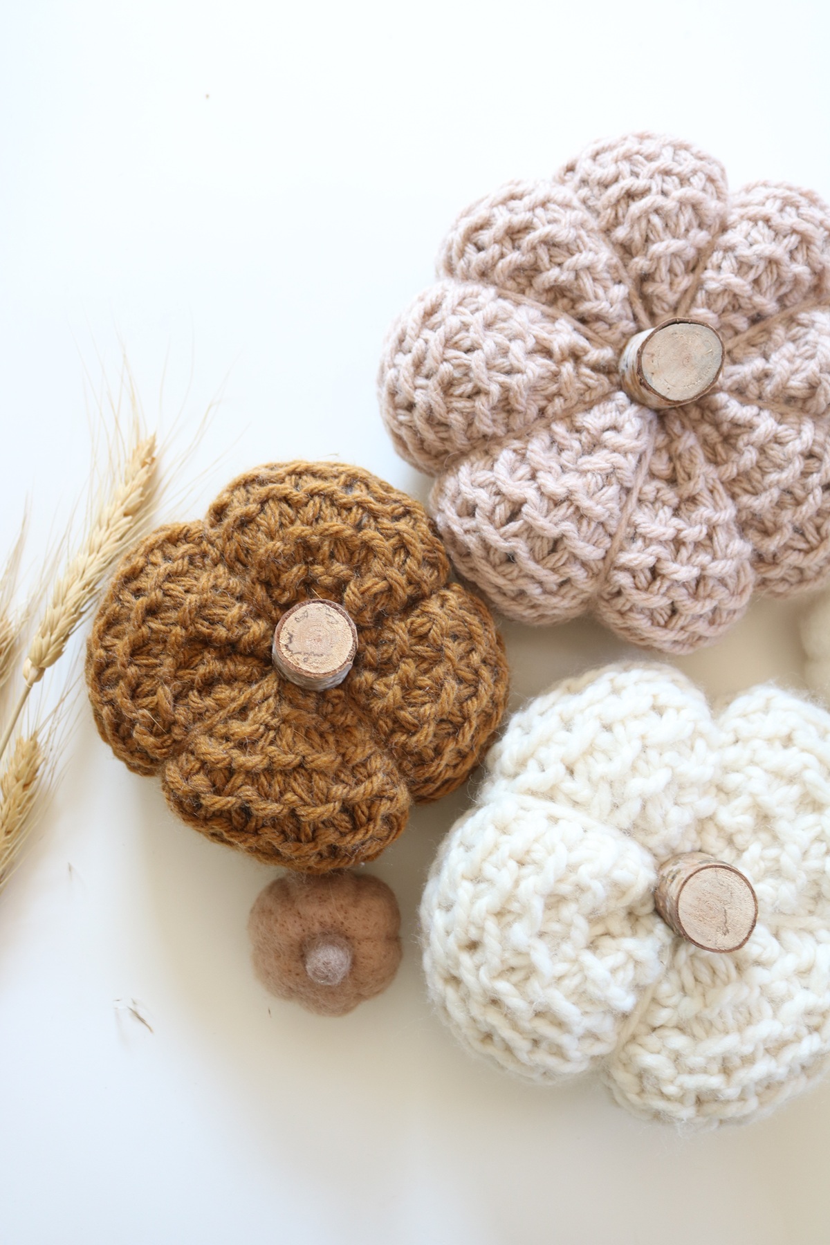 knit pumpkins displayed on table