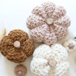 knit pumpkins displayed on table