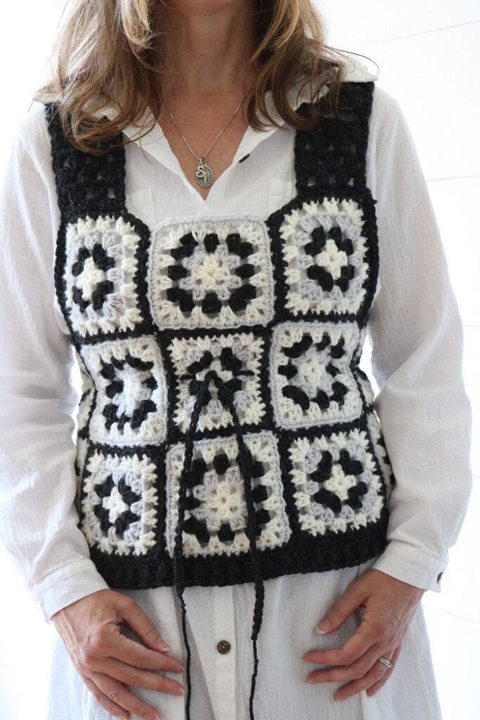 woman wearing granny square crochet vest