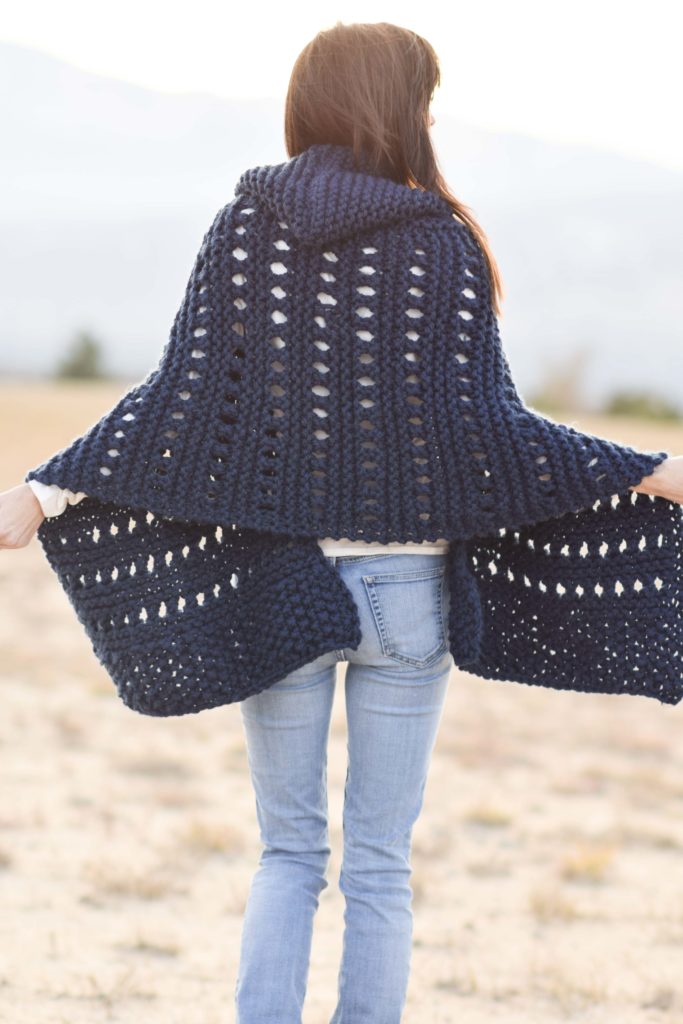woman wearing hooded knit wrap