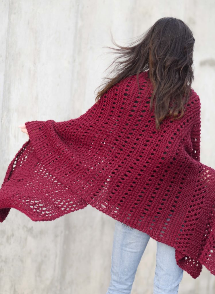 woman wearing large knit shawl