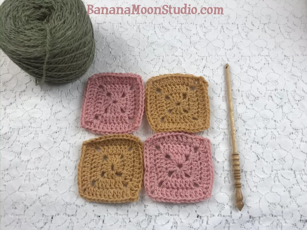 4 crochet squares on table