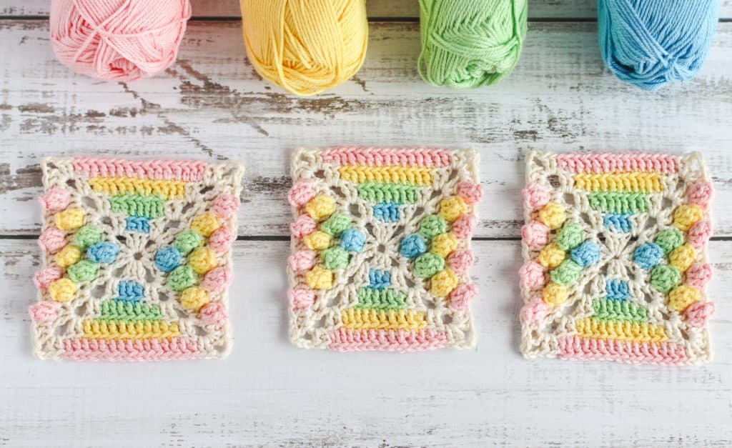 3 colorful crochet squares on table