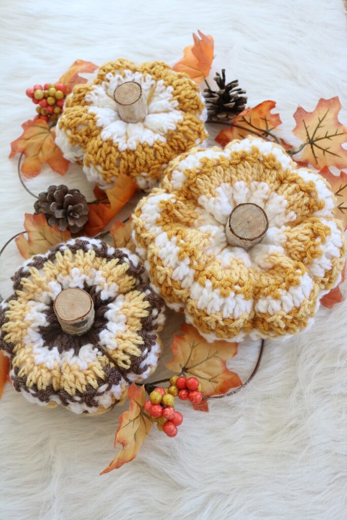 crochet pumpkins on table with garland