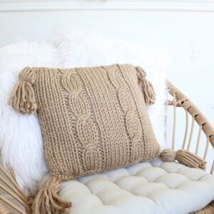 Cable Pillow Cover Knit Pattern - on chair with tufted pillow, 2 faux fur pillow, closeup