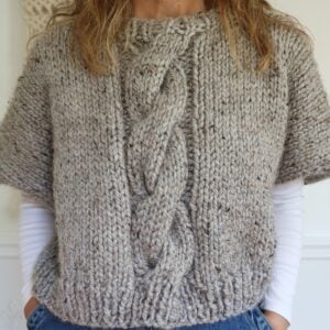 woman wearing cable knit poncho