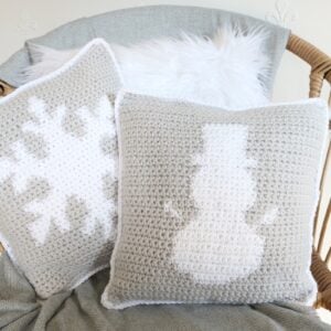 Winter Wonderland colorwork pillow - Snowman and Snowflake pillows on chair