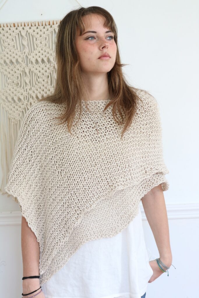 woman wearing knit cotton poncho 