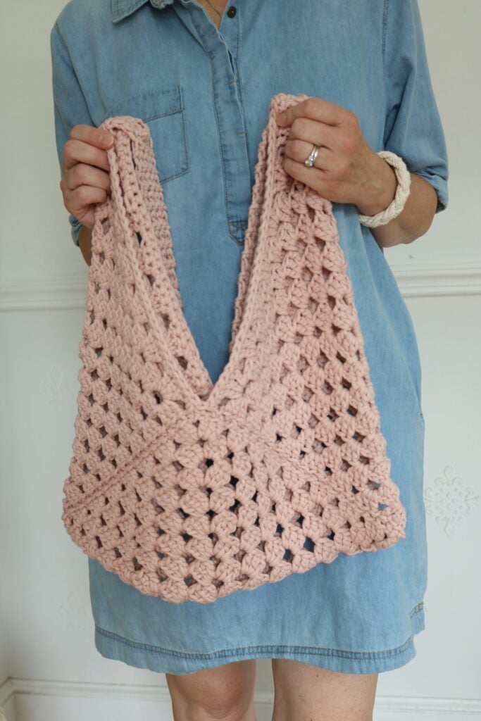 woman holding granny square crochet bag