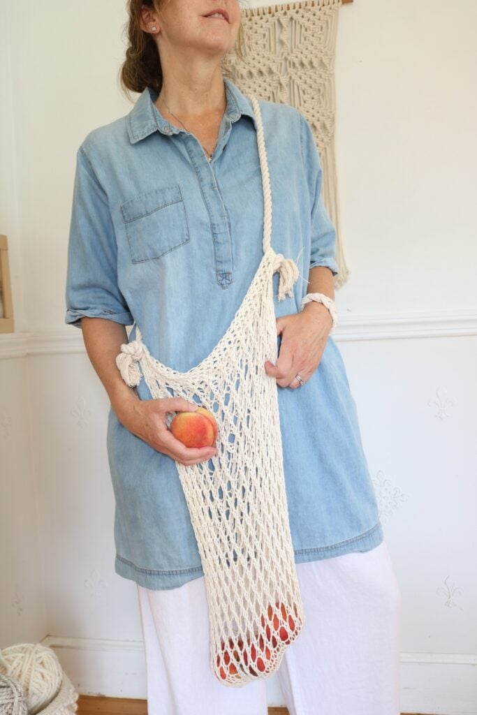 woman holding knit mesh market bag